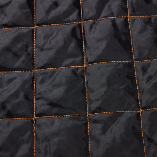 Close-up of the Drake Campfire Canvas Shirt Jac Hoodie's quilted interior, showcasing its orange-stitched insulation designed for warmth and comfort.