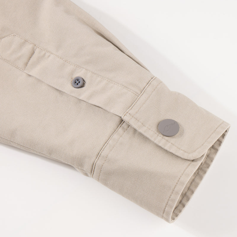 Close-up of the Campfire Canvas Shirt Jac Hoodie, highlighting buttoned cuff and placket, showcasing durable craftsmanship ideal for outdoor comfort and style.