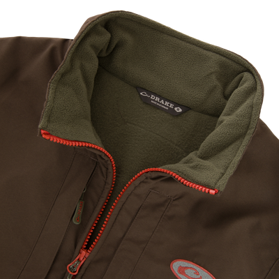 Close-up of the Drake Eqwader Vest, showcasing its waterproof upper body, fleece lower torso, and secure chest pockets for storing valuables.