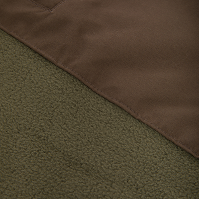 Close-up of the Drake Eqwader Vest, showcasing its waterproof upper with Magnattach™ pocket and breathable fleece lower, ideal for hunting versatility.