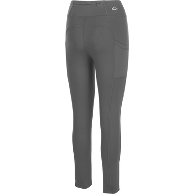 Women's Commando Solid Legging, a versatile high-performance legging with 4-way stretch fabric. Features include a 4-inch waistband, back zippered pocket, and angled side seam pockets. Quick drying and moisture-wicking for your next adventure.