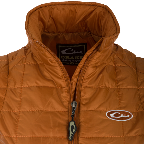 Women's Synthetic Down Pac-Vest: Close-up of jacket with label, zipper, and logo. Stay warm and ready for adventure with this water-repellant vest.
