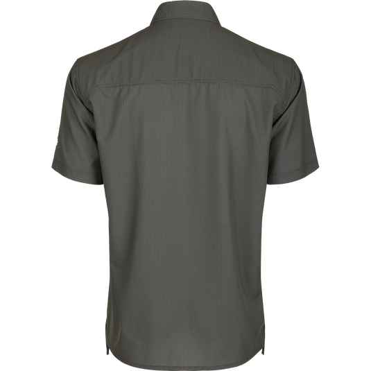 A back view of the Traveler's Check Shirt S/S, a lightweight, breathable shirt with Four Way Stretch for freedom of movement. Ideal for the man on the go, whether on vacation or running errands. Split tail hem allows for tucked or untucked wear.