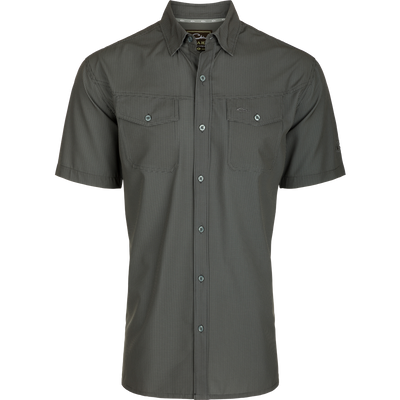 Alt text: Close-up of the Traveler's Check Button-Down Short Sleeve Shirt, featuring button flaps on chest pockets and lightweight, breathable poly/spandex fabric.
