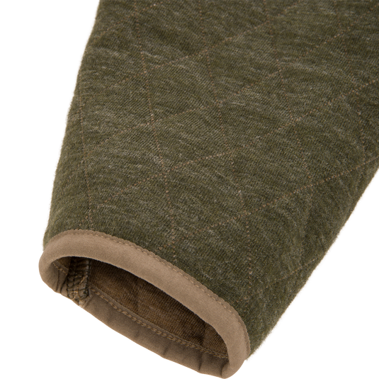 Close-up of a dark olive quilted Delta Quilted Over Under Sweatshirt sleeve with brown trim at the cuff.