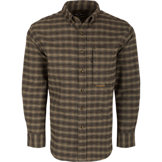 A brown plaid shirt with buttons, made from 100% brushed cotton twill. Features include a classic button-down collar, back box pleat with locker loop, and open and hidden zippered chest pockets. Perfect for a refined and sophisticated look.