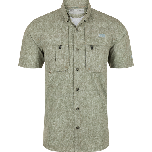 Heritage Heather Shirt S/S: A performance shirt with micro mesh fabric for natural cooling, UPF30 sun protection, and moisture-wicking properties. Features include a hidden button-down collar, vented cape back, and two chest pockets. Perfect for outdoor activities or the office.