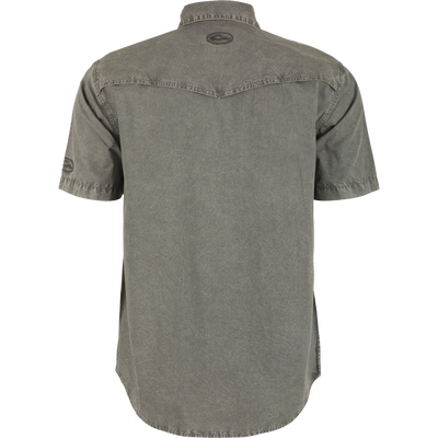 Back view of the Cinco Ranch Western Acid Washed Short Sleeve Shirt, highlighting its vented Western back cape and faux pearl snap buttons.