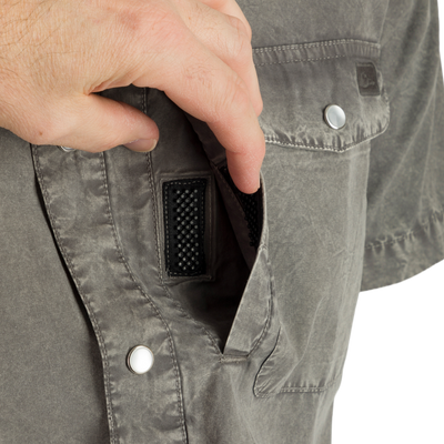 Cinco Ranch Western Acid Washed Short Sleeve Shirt with a hand demonstrating the Magnattach closure on the left chest pocket, highlighting the shirt's casual, functional design.