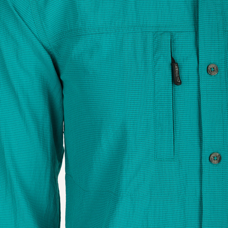 A close-up of the Classic Seersucker Minicheck Shirt, featuring a hidden button-down collar, zippered chest pocket, and Magnattach closure. Made from performance fabric with UPF30 sun protection and moisture-wicking properties. Vented cape back and split tail hem for added ventilation and versatility. Ideal for hunting, fishing, and outdoor activities.