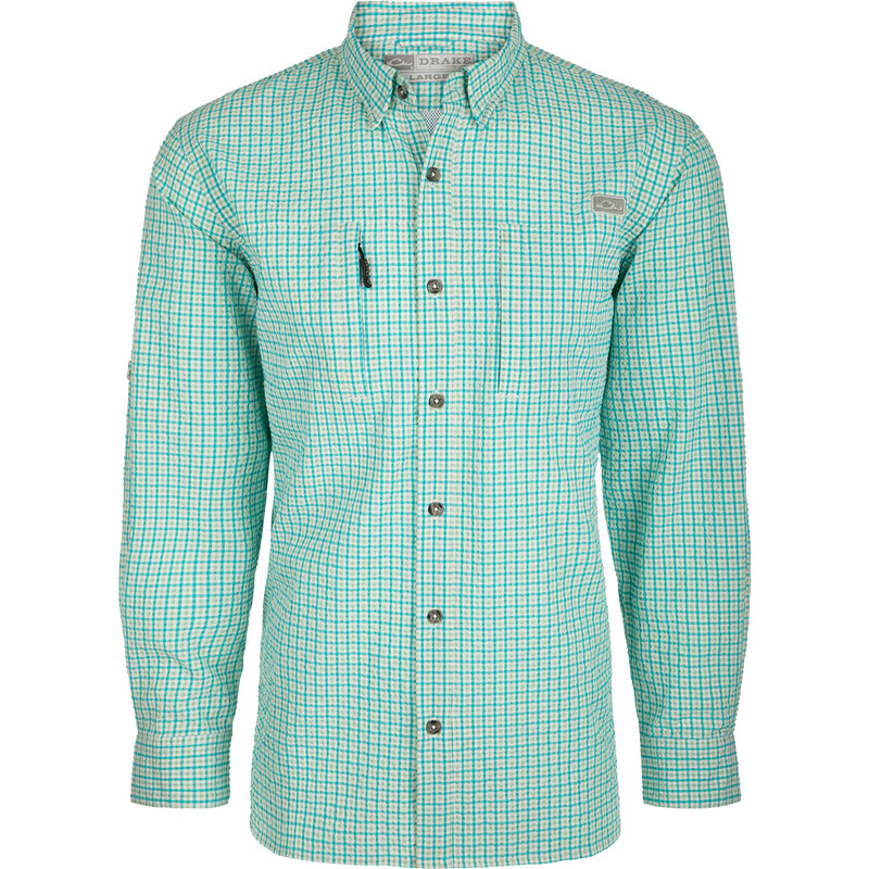 A classic seersucker grid check shirt with a hidden button-down collar, zippered chest pocket, and adjustable roll-up sleeves. Made from performance fabric for moisture-wicking and sun protection. Perfect for hunting and outdoor activities.