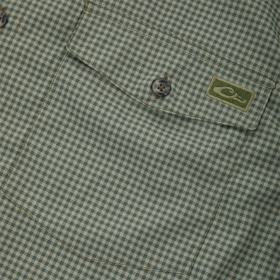 Close-up of Frat Gingham Check Button-Down Long Sleeve Shirt's chest pocket with green houndstooth fabric, buttoned flap, and embroidered logo patch.
