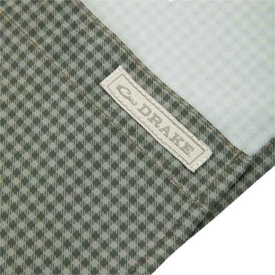 Close-up of E·DAKE label on green-and-gray houndstooth fabric of the Frat Gingham Check Button-Down Long Sleeve Shirt, highlighting its performance fabric and classic fit features.