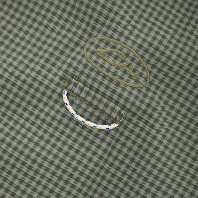 Close-up of houndstooth fabric with oval logo and cord detail, showcasing the Frat Gingham Check Button-Down Long Sleeve Shirt's technical features and casual style.