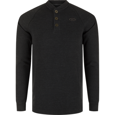 A black long sleeve Henley shirt with metal logo buttons, raglan sleeves, rib knit collar, and cuffs. Made of waffle mélange fabric for comfort, antimicrobial, and moisture-wicking properties. Split tail hem for versatile styling.