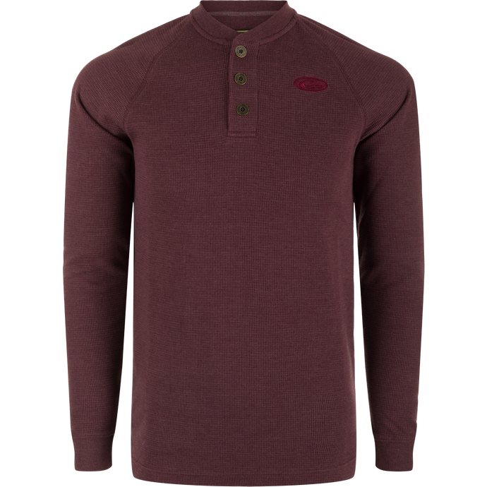 A Weston Lakes Waffle Long Sleeve Henley by Drake: Mélange fabric, raglan sleeves, metal logo buttons, rib knit collar and cuffs, split tail hem. Ideal for hunting and outdoor activities.
