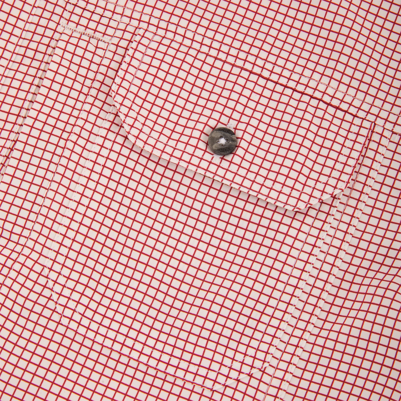 Close-up of Drake Wingshooters Trey Grid Check Short Sleeve Shirt showing a flap pocket with a dark button, highlighting grid-patterned, lightweight performance fabric.