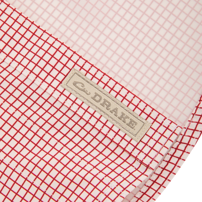 Close-up of the Wingshooters Trey Grid Check Short Sleeve Shirt highlighting the red-and-white grid fabric with “DRAKE” label, showcasing its performance features.