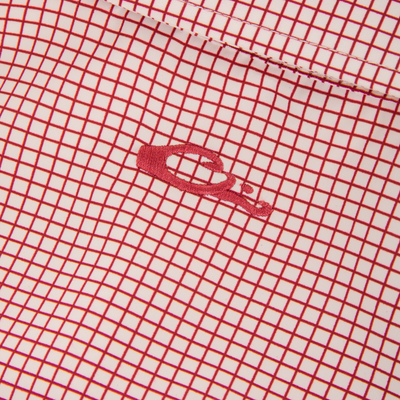 Wingshooters Trey Grid Check Short Sleeve Shirt showcasing a red grid pattern, embroidered logo, stitched seam, and performance features like moisture-wicking and UPF30 sun protection.