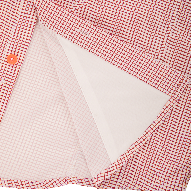 Close-up of the Drake Wingshooter Trey Grid Check Shirt's front placket, highlighting the orange button and inner interfacing layer for technical performance.