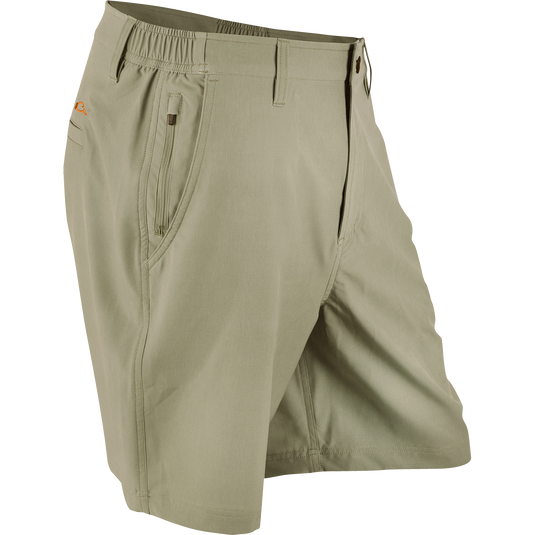 Drake Waterfowl Active Short, featuring a zipper and multiple pockets. High-performance fabric wicks moisture, breathes well, and stretches for optimal comfort. Perfect for outdoor activities. Color: Khaki.