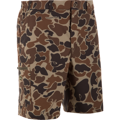Mannequin wearing Drake Traveler Trek Short with Old School Camo pattern, featuring belt loops, side pockets, and a zip-pocket on the left thigh.
