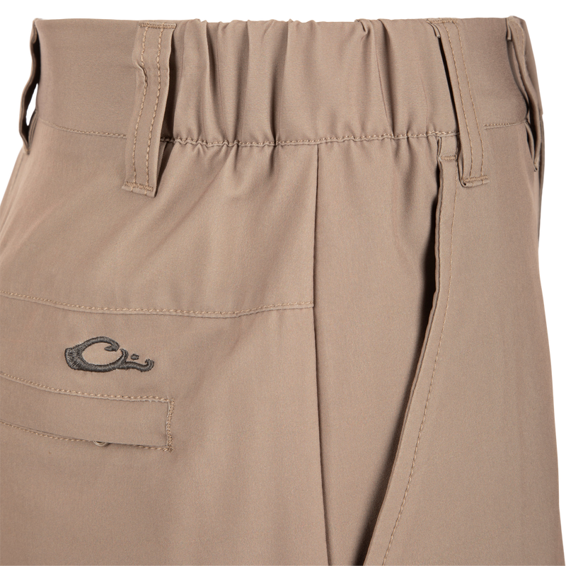 Close-up of Traveler Trek Short fabric with built-in stretch, moisture-wicking, and quick-drying features. Includes pockets and elastic waistband for comfort and functionality.