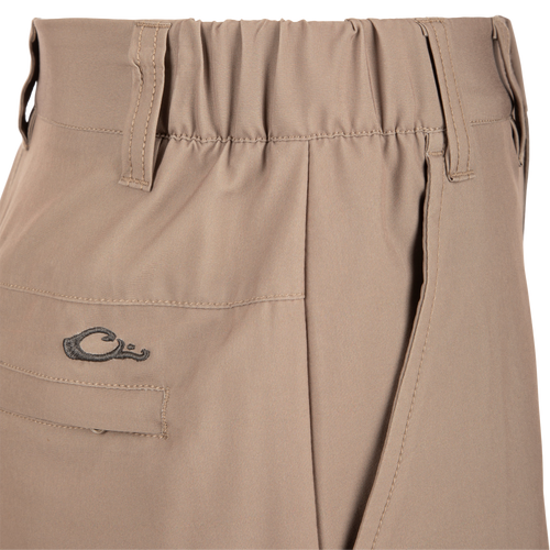 Close-up of Traveler Trek Short fabric with built-in stretch, moisture-wicking, and quick-drying features. Includes pockets and elastic waistband for comfort and functionality.
