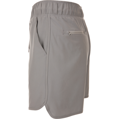 Commando Lined Volley Short 7in with built-in liner, elastic waistband, adjustable drawstring, scalloped hem, and zippered back pockets, ideal for versatile outdoor activities.