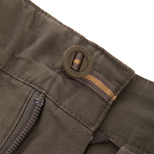 Close-up of 9 Pocket Ripstop Short's waistband, featuring a DRAKE buckle, zipper, and reinforced stitching; designed for adventure with self-adjusting fit and multiple pockets.