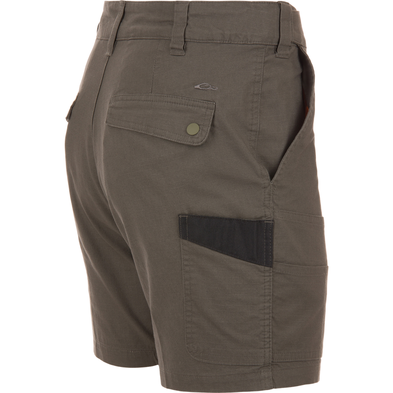 Back and side view of olive-green 9 Pocket Ripstop Short on mannequin, featuring snap-flap back pocket, side pocket with darker insert, and self-adjusting waistband.