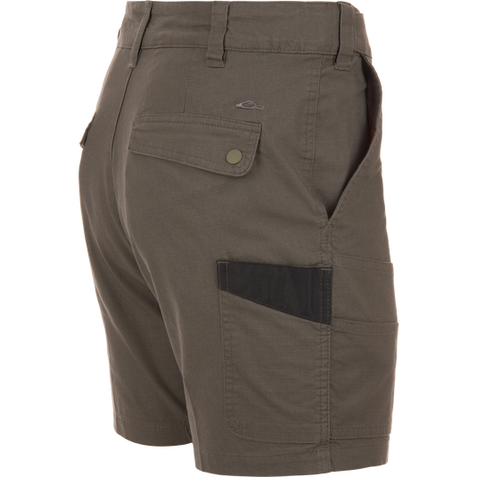 Back and side view of olive-green 9 Pocket Ripstop Short on mannequin, featuring snap-flap back pocket, side pocket with darker insert, and self-adjusting waistband.