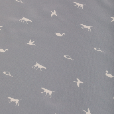 Performance Print Polo Shirt with grey fabric featuring white animals like dogs and birds. Equipped with a self-fabric collar, open cuffs, and split hem.