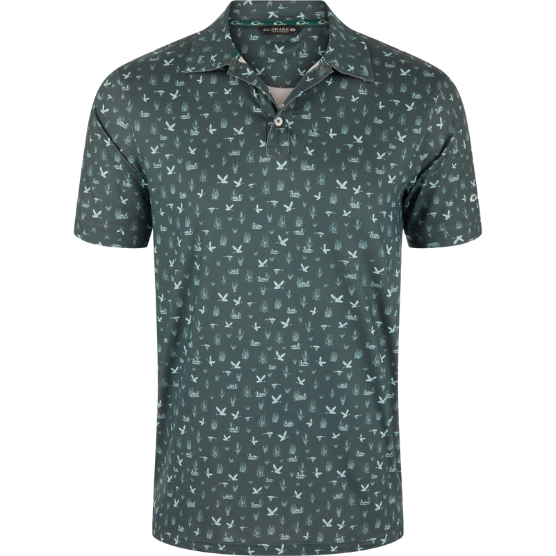 Marsh Duck Polo featuring a deep olive-green hue with light-green flying ducks and marsh grasses pattern, classic collar, and two-button placket in a performance fabric.