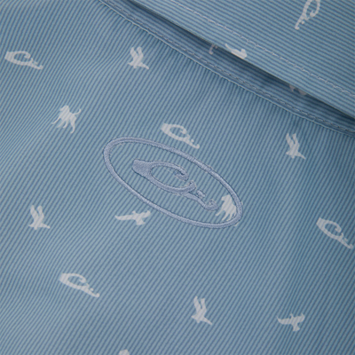 Close-up of Drake Cinco Ranch Western Short Sleeve Shirt's pale blue lining with white nautical prints and embroidered brand logo.