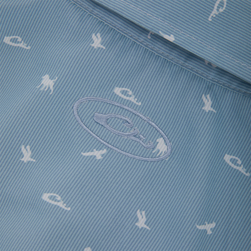 Close-up of Drake Cinco Ranch Western Short Sleeve Shirt's pale blue lining with white nautical prints and embroidered brand logo.