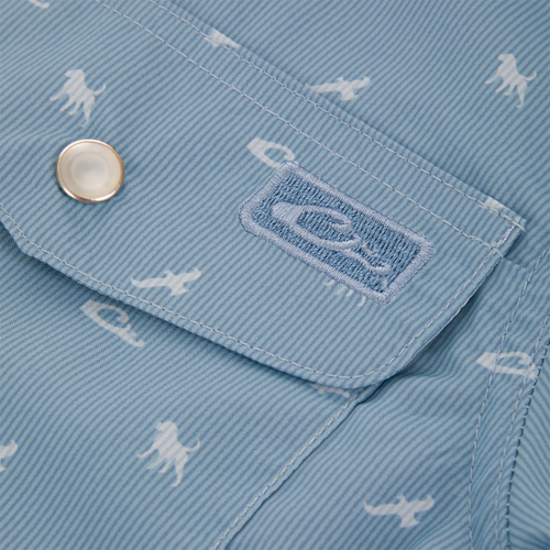 Cinco Ranch Western Short Sleeve Shirt flap, featuring a metal snap and embroidered logo, with sea creature print on light-blue, fine-striped fabric.