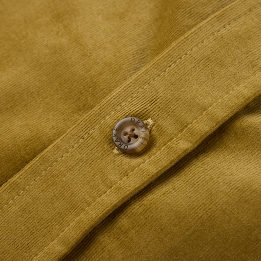 Close-up of the Drake Mid-Wale Corduroy Shirt, showcasing a horn-style button engraved with DRAKE on a stitched placket, highlighting its refined craftsmanship.