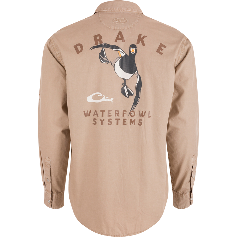 Back view of Cinco Ranch Cotton Acid Wash Graphic Shirt featuring DRAKE text, flying duck graphic, and WATERFOWL SYSTEMS. Rounded hem and buttoned cuffs visible.