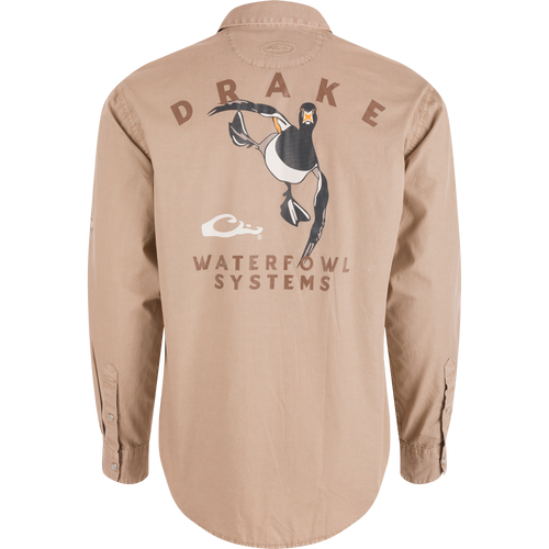 Back view of Cinco Ranch Cotton Acid Wash Graphic Shirt featuring DRAKE text, flying duck graphic, and WATERFOWL SYSTEMS. Rounded hem and buttoned cuffs visible.