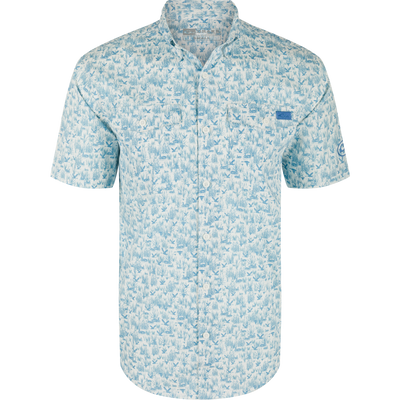 Cotton Marsh Print Short Sleeve Shirt featuring light-blue nature print, button-down collar, chest pockets, and sculpted hem, displayed on a hanger, embodying Drake Waterfowl's casual style.