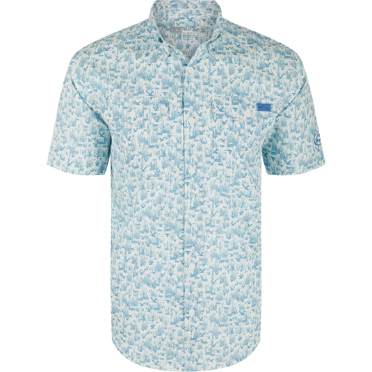 Cotton Marsh Print Short Sleeve Shirt featuring light-blue nature print, button-down collar, chest pockets, and sculpted hem, displayed on a hanger, embodying Drake Waterfowl's casual style.