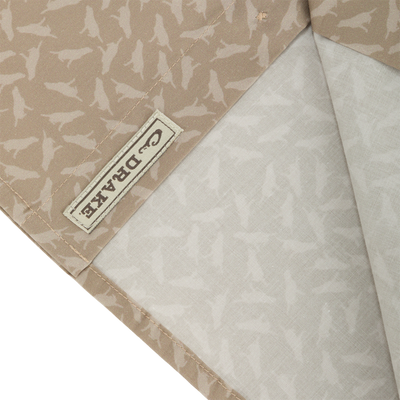 Close-up of Cotton Lab Print Short Sleeve Shirt, showcasing the soft cotton blend poplin fabric with a label detail, highlighting its lightweight and versatile design.