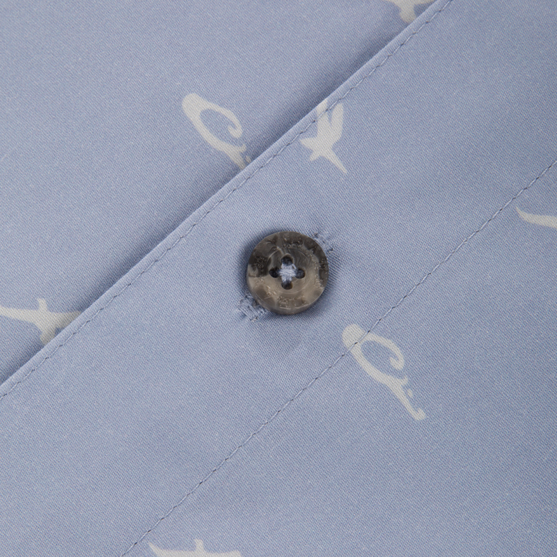 Close-up of the Cotton DDD Print Shirt featuring a subtle white motif and a grey marbled button on the placket seam.