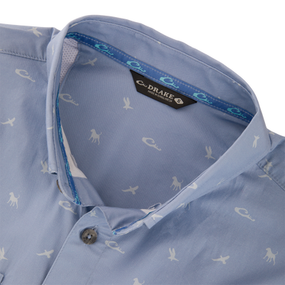 Cotton DDD Print Shirt: Light blue button-up shirt with white animal silhouettes, open collar showing blue-turquoise tape, and visible Drake label.