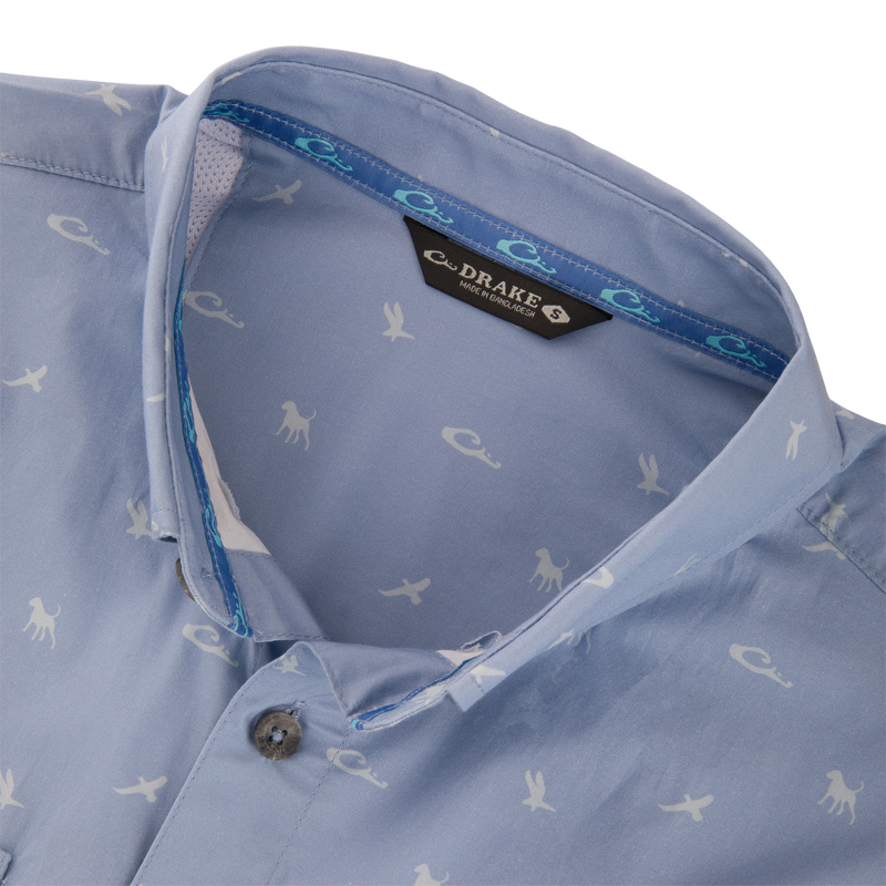 Cotton DDD Print Shirt: Light blue button-up shirt with white animal silhouettes, open collar showing blue-turquoise tape, and visible Drake label.