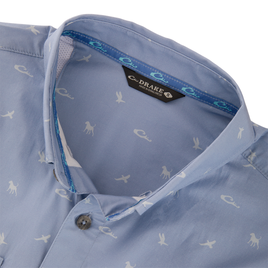 Cotton DDD Print Shirt: Light blue button-up shirt with white animal silhouettes, open collar showing blue-turquoise tape, and visible Drake label.