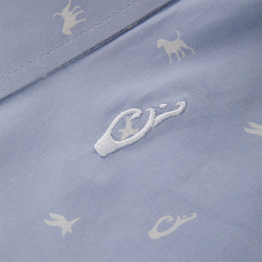 Close-up of the Cotton DDD Print Shirt, showcasing tiny white animal silhouettes and a central embroidered logo on pale blue fabric, reflecting Drake Waterfowl's signature casual style.
