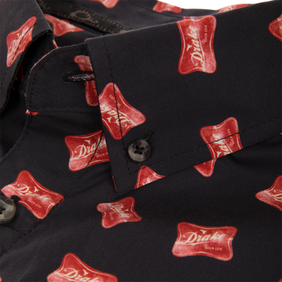 Close-up of Cotton Drake Life Print Short Sleeve Shirt, showcasing black button-up with red Drake logo pattern, button-down collar, and button-through flap pocket.