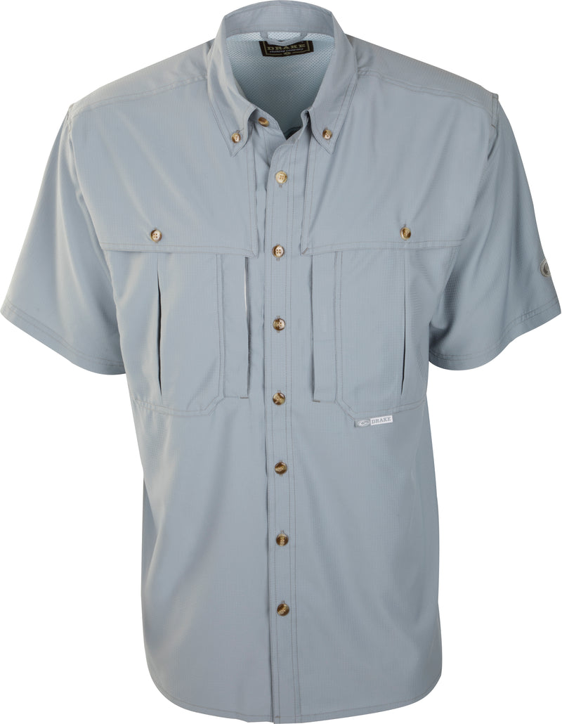 A gray Flyweight Wingshooter's Shirt S/S: Grey shirt with buttons, pockets, and vented back. Made of ultra-lightweight Flyweight polyester for quick-drying, moisture-wicking comfort. Ideal for warm-weather outdoor activities.